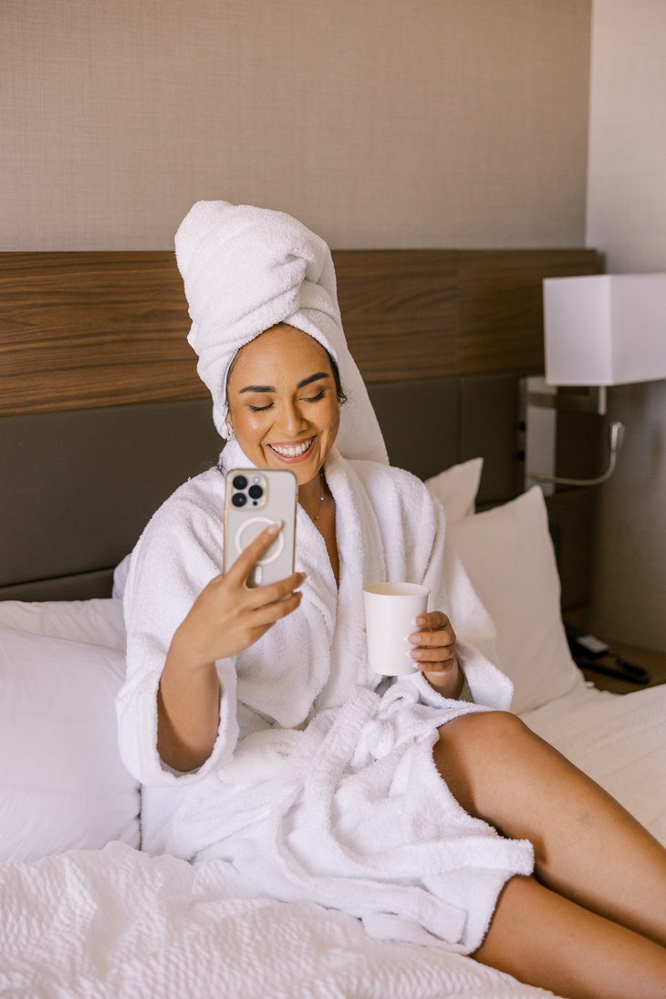 Staycation Woman Relaxing on Hotel Bed